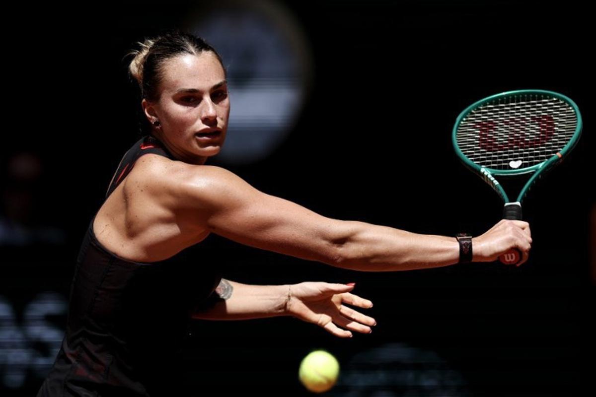 Belarus' Aryna Sabalenka plays a backhand return to Spain's Jessica Bouzas Maneiro during their women's singles match on day 3 of the French Open tennis tournament on Court Philippe-Chatrier at the Roland-Garros Complex in Paris on May 26, 2026. Anne-Christine POUJOULAT / AFP