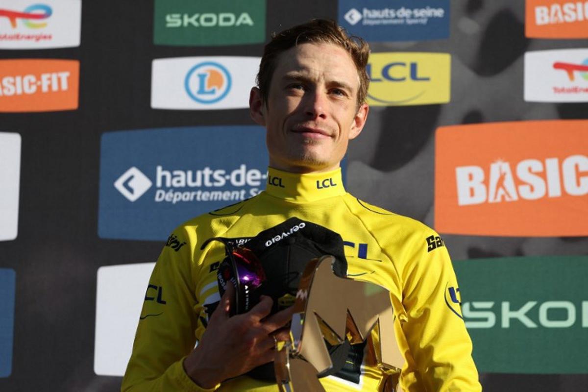 Team Visma - Lease a Bike's Danish rider Jonas Vingegaard celebrates with the trophy after winning the 2026 Paris-Nice cycling race, on March 15, 2026. Anne-Christine POUJOULAT / AFP