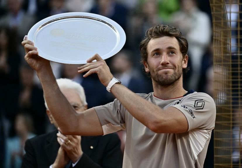Norway's Casper Ruud holds a trophy after the match against Italy's Jannik Sinner in their men's final of the ATP Rome Open tennis tournament at the Foro Italico in Rome on May 17, 2026. Filippo MONTEFORTE / AFP