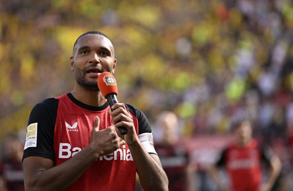 Bayer Leverkusen's German outgoing defender #04 Jonathan Tah thanks supporters after the German first division Bundesliga football match between Bayer 04 Leverkusen and Borussia Dortmund in Leverkusen, western Germany, on May 11, 2025. INA FASSBENDER / AFP