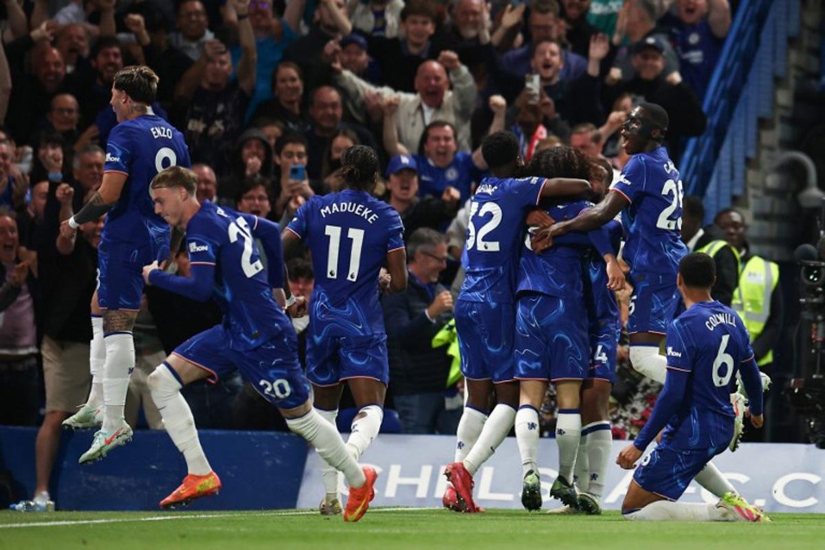Chelsea's Spanish defender #03 Marc Cucurella (unseen) celebrates with teammates after scoring his team first goal during the English Premier League football match between Chelsea and Manchester United at Stamford Bridge in London on May 16, 2025. HENRY NICHOLLS / AFP