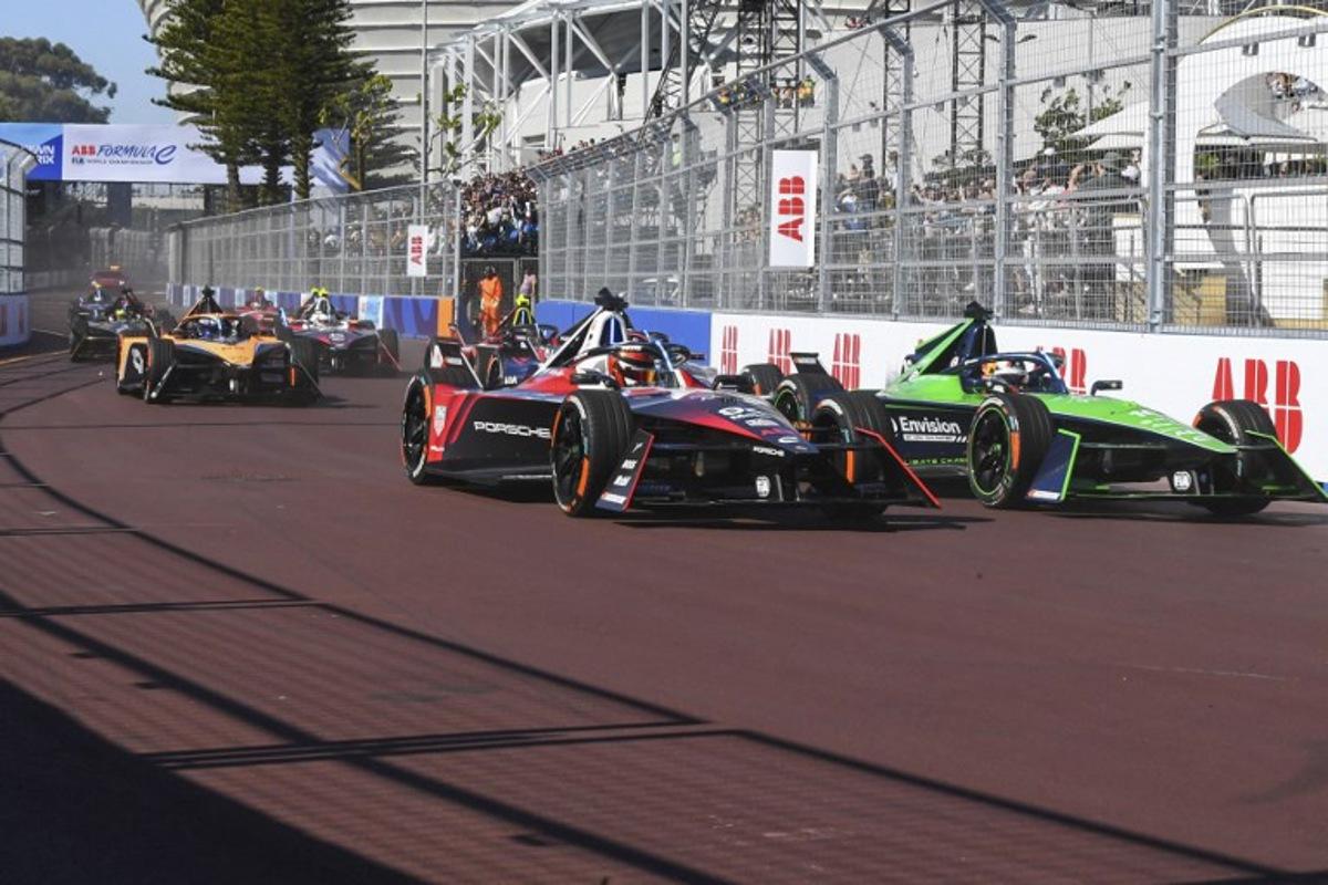 Tag Huer Porche's driver Pascal Wehrlein (L) and Envision Racing's driver Sebastien Buemi (R) drive during the 2023 Cape Town E-Prix in Cape town on February 25, 2023. Rodger Bosch / AFP