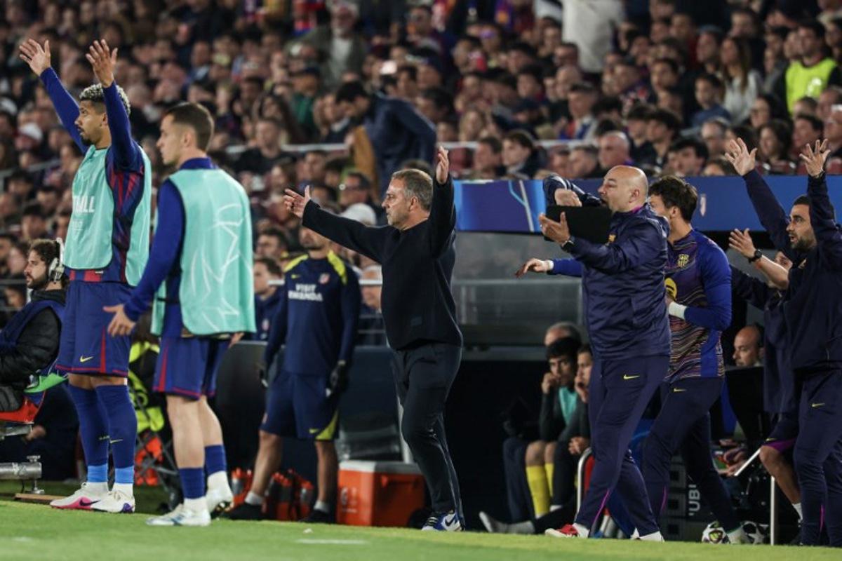 Barcelona's German coach Hans-Dieter Flick (C) gestures during the UEFA Champions League quarter final first leg football match between FC Barcelona and Club Atletico de Madrid at Camp Nou Stadium in Barcelona on April 8, 2026. Lluis GENE / AFP