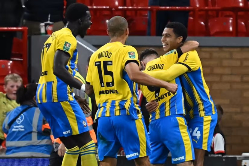 Southampton's Northern Irish midfielder #24 Shea Charles (R) celebrates with teammates after scoring their first goal during the English League Cup third round football match between Liverpool and Southampton at Anfield in Liverpool, north west England on September 23, 2025. Paul ELLIS / AFP