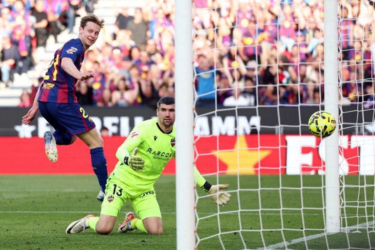 Barcelona's Dutch midfielder #21 Frenkie De Jong scores his team's second goal during the Spanish league football match between FC Barcelona and Levante UD at Camp Nou Stadium in Barcelona on February 22, 2026. Josep LAGO / AFP