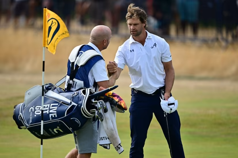 Belgium's Thomas Detry shakes hands with his caddie Lee Warne after his second round 69 on day two of the 154th Open Golf championship at Royal Birkdale Golf Club near Southport in north-west England on July 17, 2026. Ben STANSALL / AFP