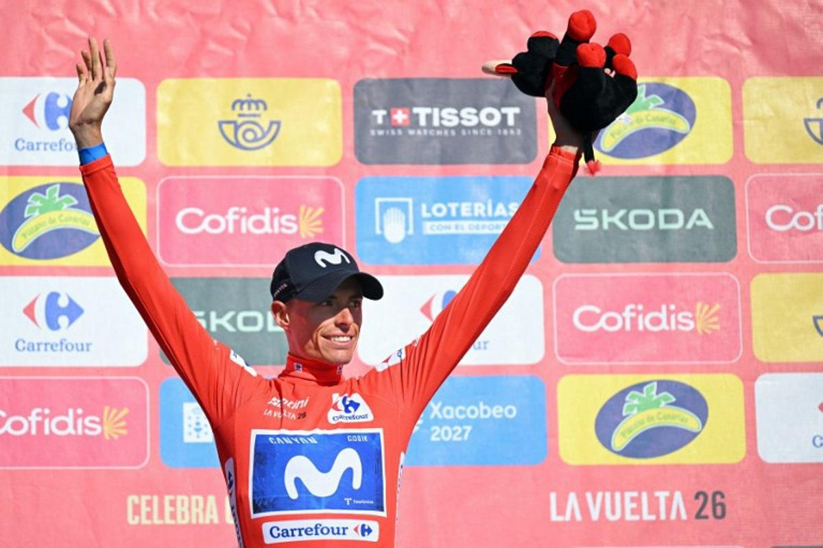 Overall leader Team Movistar's Spanish rider Enric Mas celebrates on the podium retaining the red jersey after the 20th stage of the Vuelta a Espana 2026 cycling tour, a 186,8 km race between La Calahorra and Collado del Alguacil, on September 12, 2026. Home favourite Enric Mas moved to the brink of Vuelta a Espana victory today as he finished the 20th and penultimate stage by extending his lead on Primoz Roglic in the overall standings. JORGE GUERRERO / AFP