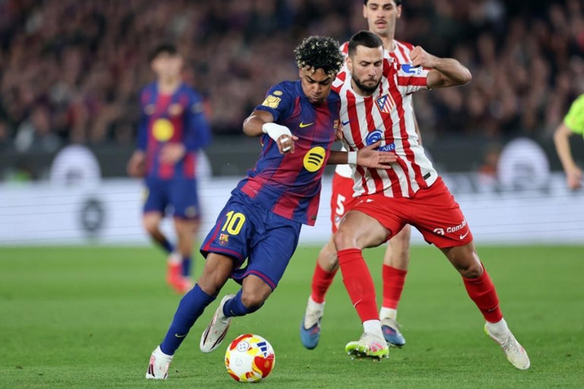 Barcelona's Spanish forward #10 Lamine Yamal and Atletico Madrid's Slovak defender #17 David Hancko fight for the ball during the Copa del Rey (King's Cup) semi final second leg football match between FC Barcelona and Club Atletico de Madrid at Camp Nou Stadium in Barcelona on March 3, 2026. Josep LAGO / AFP