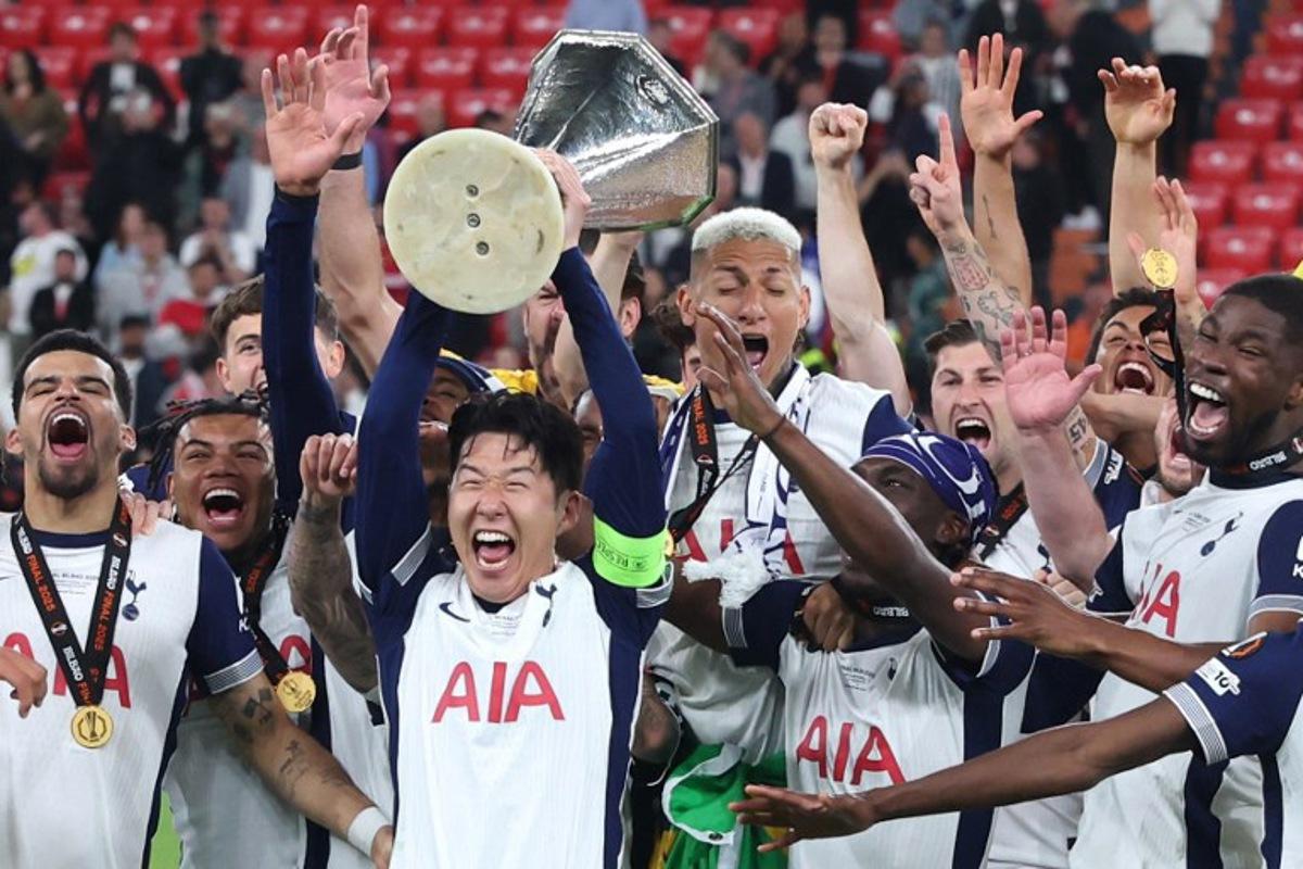 Tottenham Hotspur's players including South Korean forward #07 Son Heung-Min celebrate with the trophy after the UEFA Europa League final football match between Tottenham Hotspur and Manchester United at the San Mames stadium in Bilbao on May 21, 2025. Pierre-Philippe MARCOU / AFP