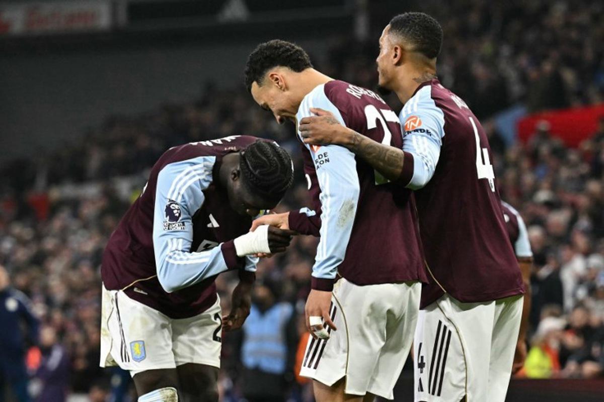 Aston Villa's English midfielder #27 Morgan Rogers (C) celebrates scoring his team's first goal to take the lead 1-0 during the English Premier League football match between Aston Villa and Manchester United at Villa Park in Birmingham, central England on December 21, 2025. Ben STANSALL / AFP
