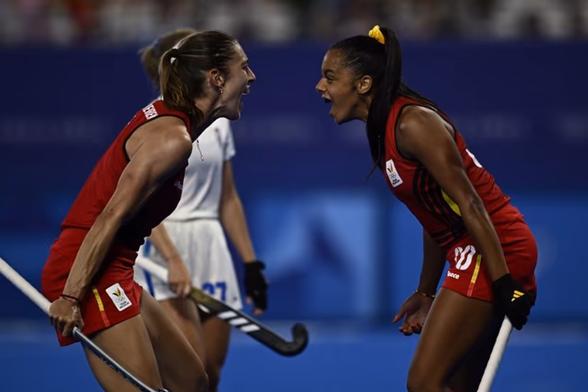 Belgium's forward #30 Ambre Ballenghien celebrates with Belgium's midfielder #07 Judith Vandermeiren after scoring her team's fifth goal in the women's pool A field hockey match between France and Belgium during the Paris 2024 Olympic Games at the Yves-du-Manoir Stadium in Colombes on July 29, 2024. JULIEN DE ROSA / AFP