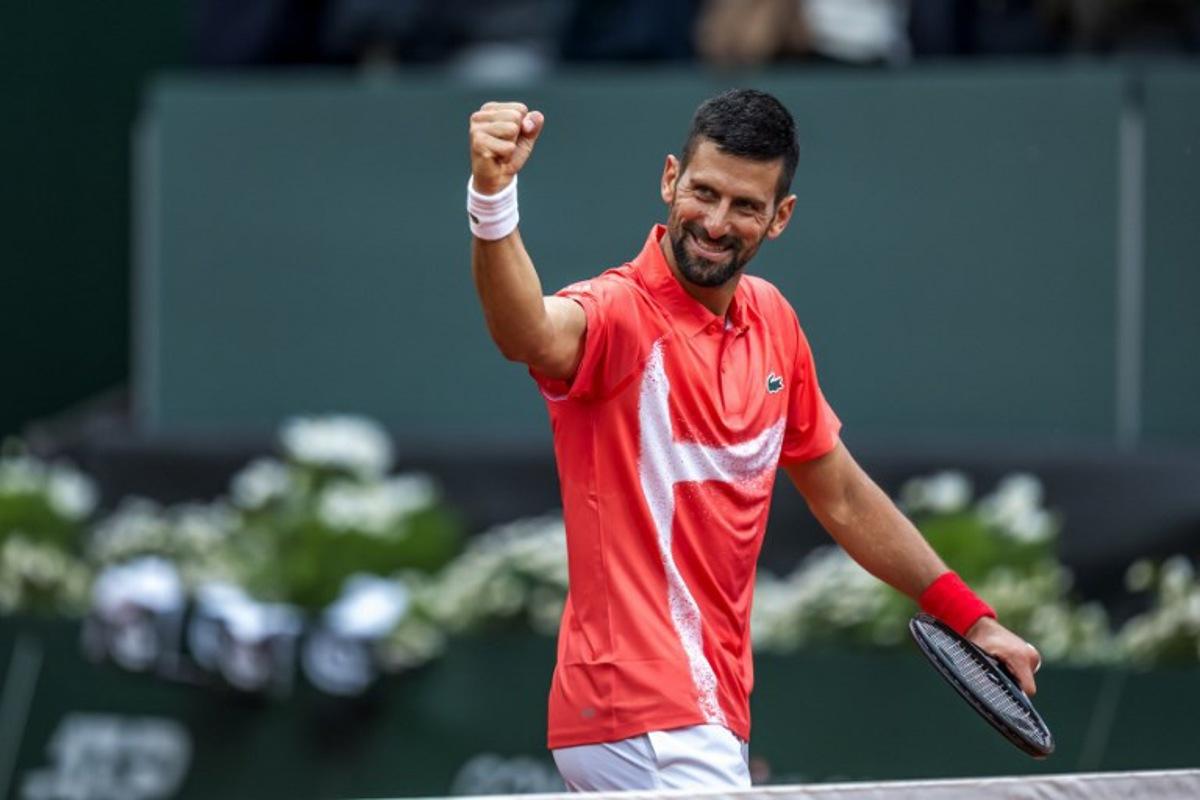 Serbia's Novak Djokovic celebrates his victory at the end of his match against Hungary's Marton Fucsovics at the ATP 250 Geneva Open tennis tournament in Geneva on May 21, 2025. FABRICE COFFRINI / AFP
