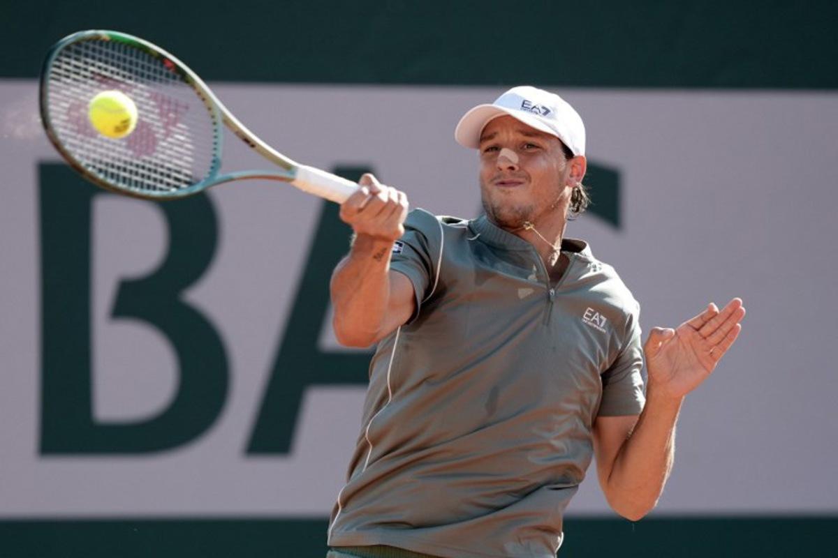 Italy's Luciano Darderi plays a forehand return to Austria's Sebastian Ofner during their men's singles match on day 3 of the French Open tennis tournament at the Roland-Garros Complex in Paris on May 26, 2026. Dimitar DILKOFF / AFP