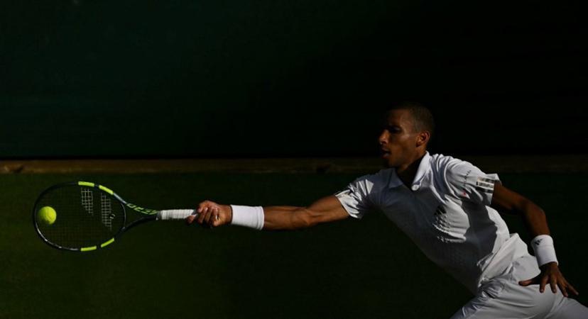 Canada's Felix Auger-Aliassime returns to Spain's Alejandro Davidovich Fokina during their men's singles round of 16 tennis match on the seventh day of the 2026 Wimbledon Championships at The All England Lawn Tennis and Croquet Club in Wimbledon, southwest London, on July 5, 2026. Glyn KIRK / AFP