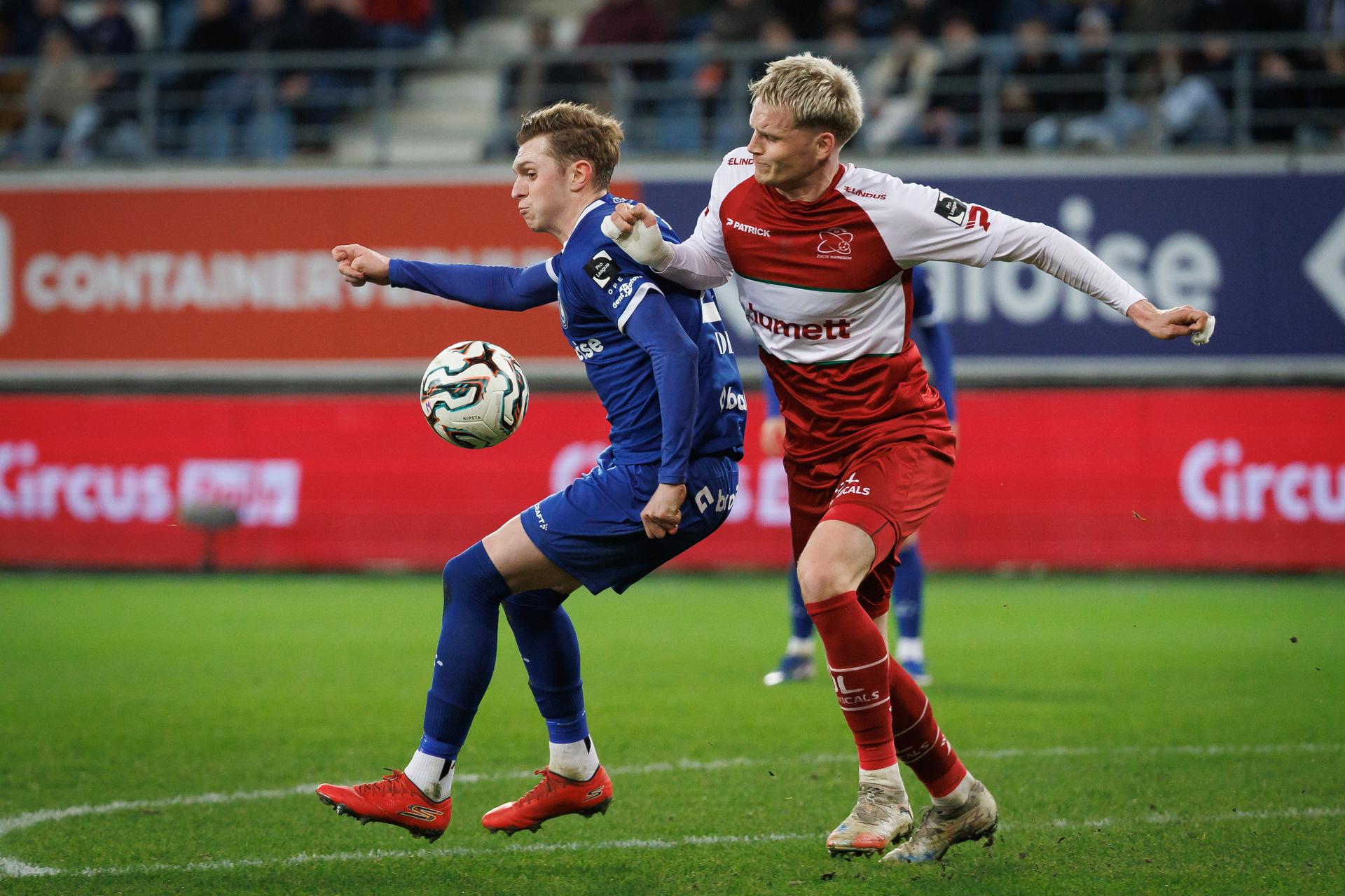 Gent's Max Dean and Essevee's Jakob Kiilerich fight for the ball during a soccer match between KAA Gent and Zulte Waregem, Friday 13 March 2026 in Gent, on day 29 of the 2025-2026 'Jupiler Pro League' first division of the Belgian championship. BELGA PHOTO KURT DESPLENTER