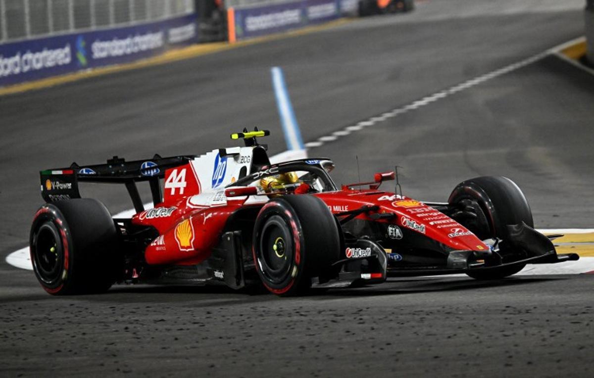 Ferrari's British driver Lewis Hamilton drives during the Formula One Singapore Grand Prix at the Marina Bay Street Circuit in Singapore on October 11, 2026. ROSLAN RAHMAN / AFP