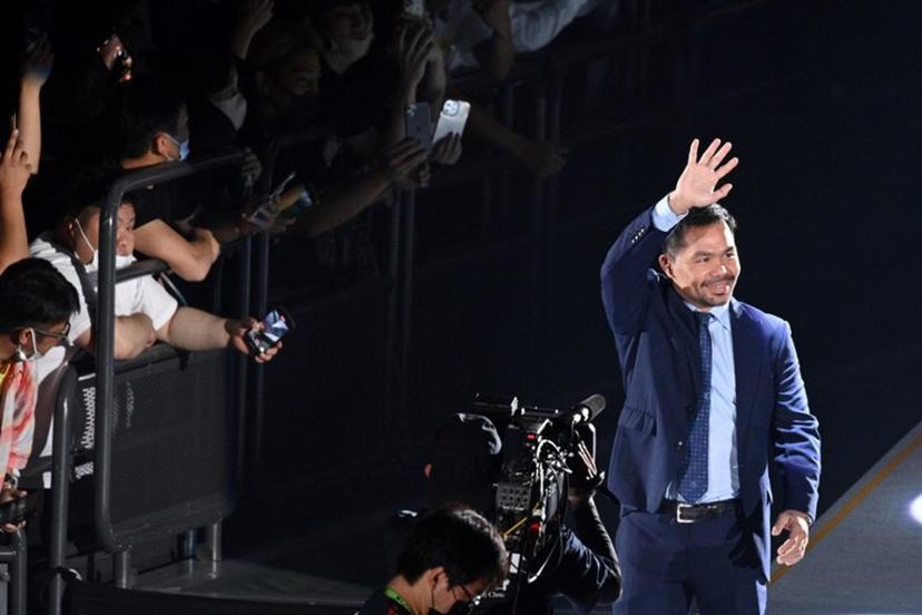 Boxing legend Manny Pacquiao of the Philippines (R) waves as he enters the arena to attend the exhibition match between US boxer Floyd Mayweather and Japanese mixed martial artist Mikuru Asakura at the Saitama Super Arena in Saitama on September 25, 2022. Philip FONG / AFP