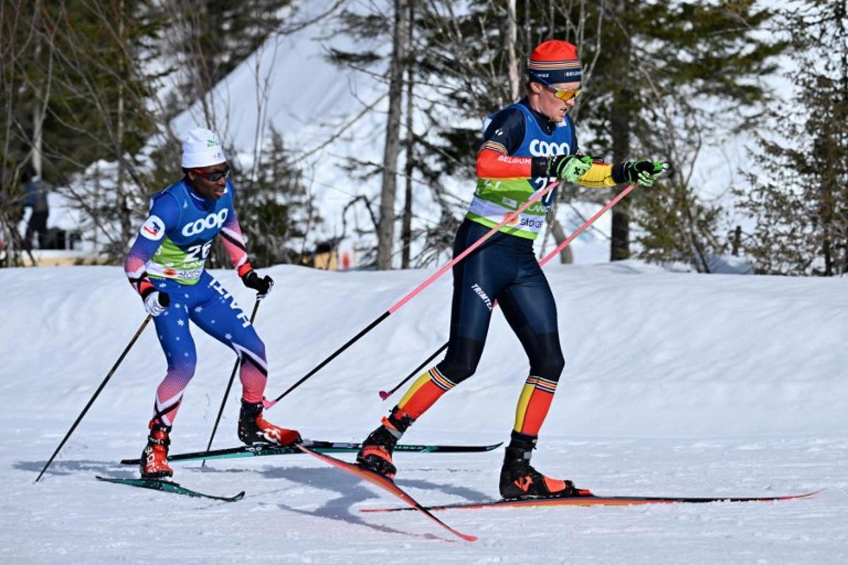 Belgium's Mathis Poutot (R) skis ahead of Haiti's Theo Mallett during the Men's Cross-Country 10km Free qualification of the FIS Nordic World Ski Championships in Planica on February 22, 2023. Joe Klamar / AFP