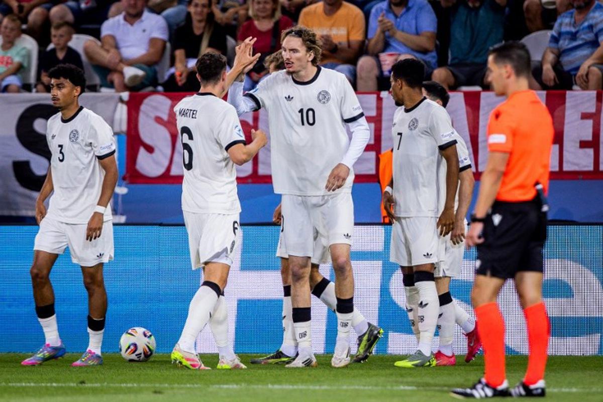 Germany's forward #10 Nick Woltemade (C), Germany's midfielder #06 Eric Martel (2nd L) and teammates celebrate after Germany scored a goal during the UEFA U21 European Championship semi-final football match between Germany and France in Kosice, Slovakia on June 25, 2025. Branislav Racko / AFP