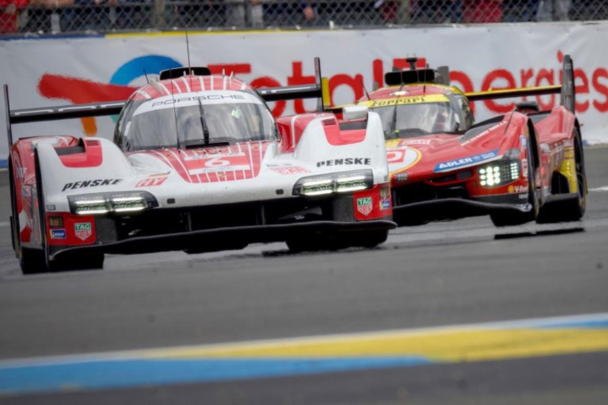 Porsche Penske Motorsport's French driver Kevin Estre steers his Porsche 963 (L) ahead of Ferrari AF Corse's Italian driver Antonio Fuoco (R) during the Le Mans 24-hours endurance race in Le Mans, western France, on June 15, 2024. GUILLAUME SOUVANT / AFP