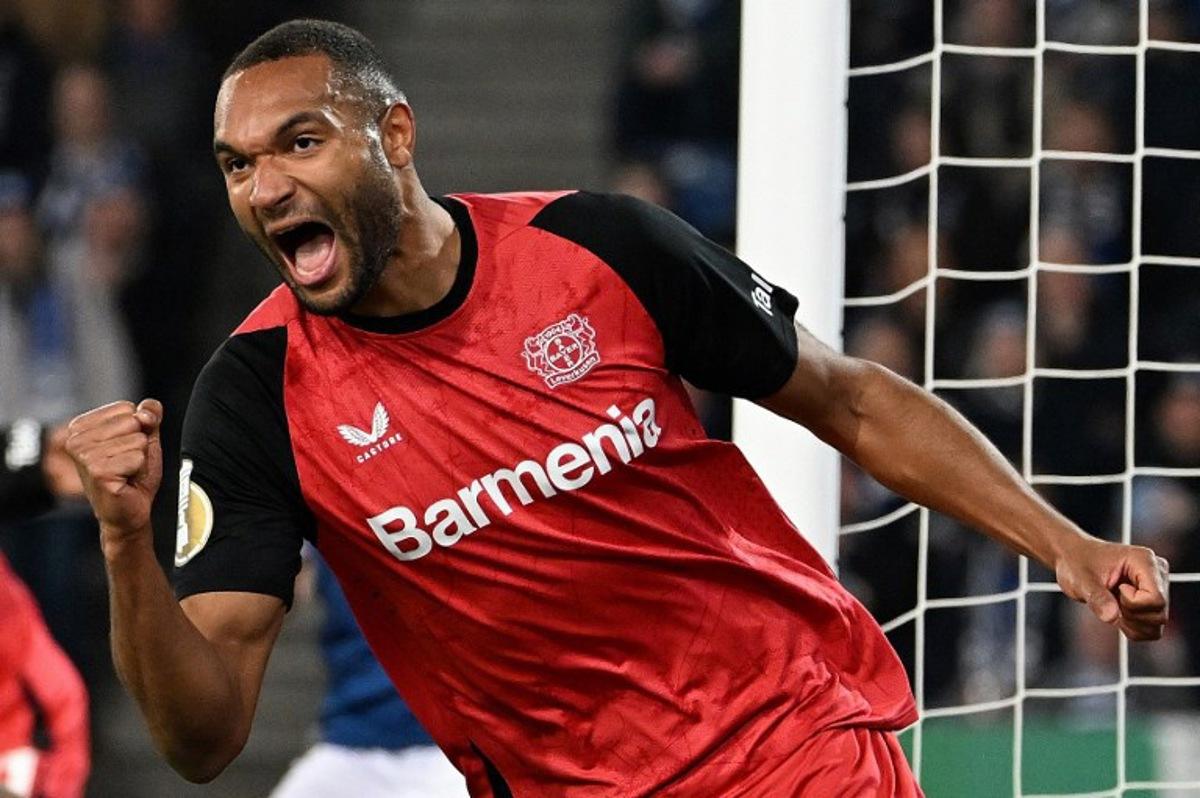 Bayer Leverkusen's German defender #04 Jonathan Tah celebrates scoring the opening goal with his teammates during the German Cup (DFB Pokal) semi-final football match between Arminia Bielefeld and Bayer 04 Leverkusen in Bielefeld, western Germany on April 1, 2025. UWE KRAFT / AFP