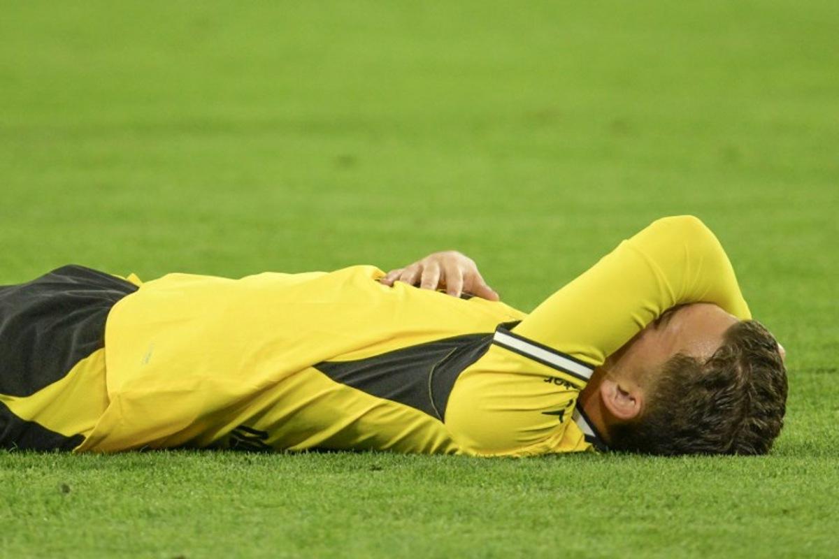 Borussia Dortmund's Greek midfielder #19 Konstantinos Karetsas lays on the pitch after injury during the UEFA Champions League - League phase, Matchday 1 - football match between BVB Borussia Dortmund and Villarreal CF in Dortmund, western Germany, on September 8, 2026. Sascha Schuermann / AFP
