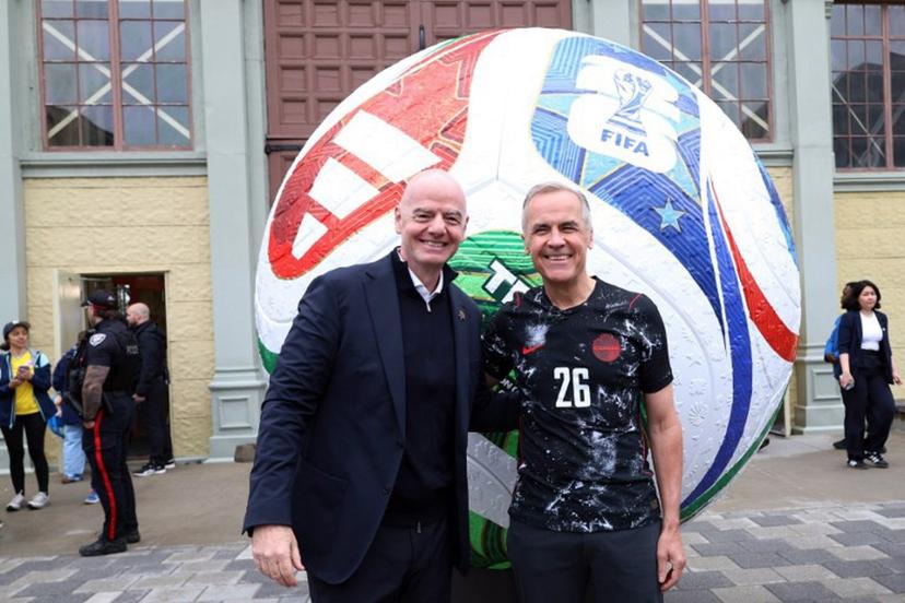 Canada's Prime Minister Mark Carney (R) and FIFA President Giovanni Infantino pose during the FIFA & Coca Cola World Cup Trophy Tour at Park Landsdowne Stadium in Ottawa, Canada, on May 24, 2026. Dave Chan / AFP