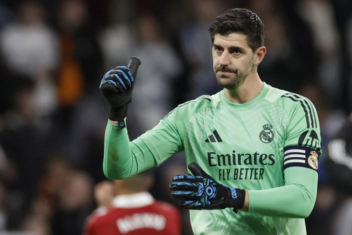 Real Madrid's Belgian goalkeeper #01 Thibaut Courtois celebrates at the end of the Spanish league football match between Real Madrid CF and Sevilla FC at Santiago Bernabeu Stadium in Madrid on December 20, 2025. Oscar DEL POZO / AFP