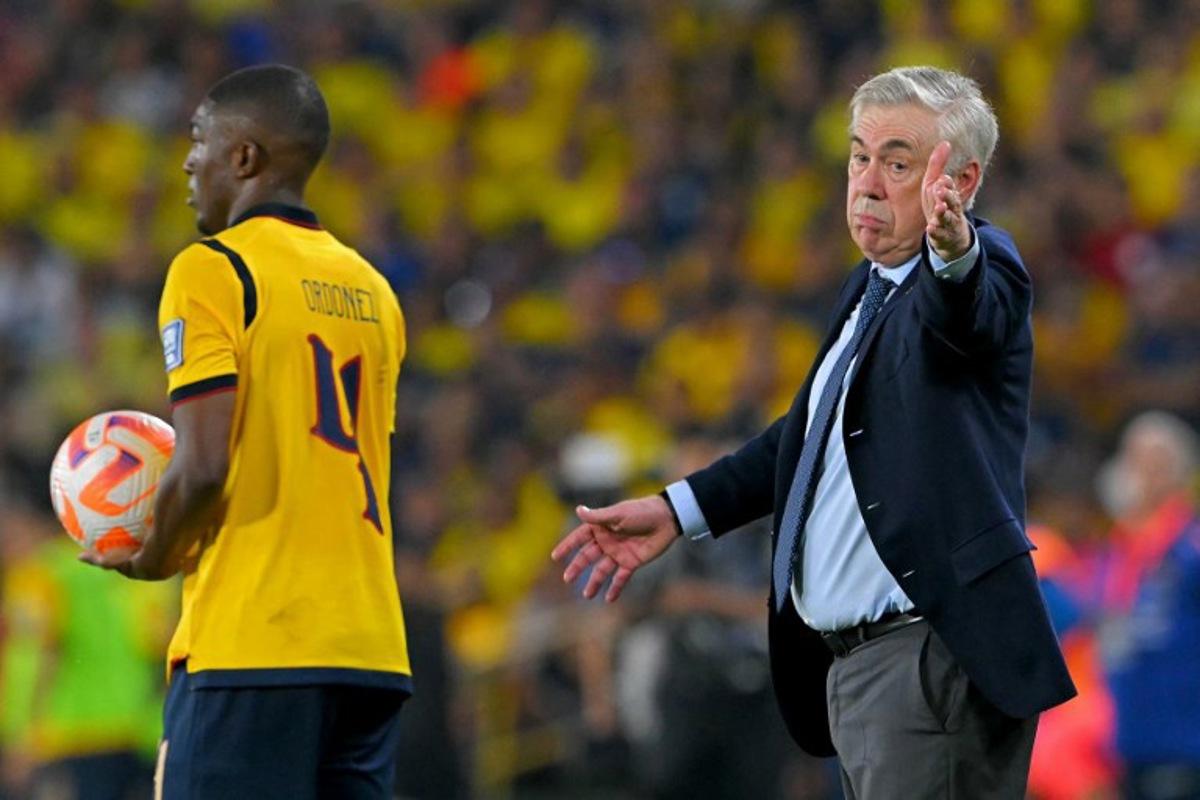 Brazil's Italian head coach Carlo Ancelotti gestures past Ecuador's defender #04 Joel Ordonez during the 2026 FIFA World Cup South American qualifiers football match between Ecuador and Brazil at the Monumental Banco Pichincha stadium in Guayaquil, province of Guayas, Ecuador on June 5, 2025. Rodrigo BUENDIA / AFP