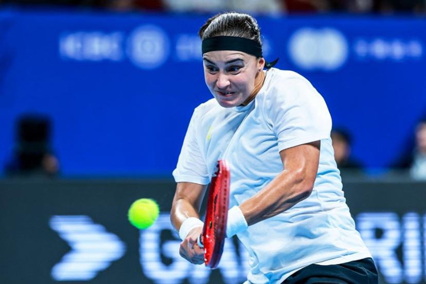 Ukraine's Anhelina Kalinina hits a return to Italy's Tyra Grant during their women's singles semi-final match at the Billie Jean King Cup tennis tournament in Shenzhen, in China's southern Guangdong province on September 26, 2026. CN-STR / AFP