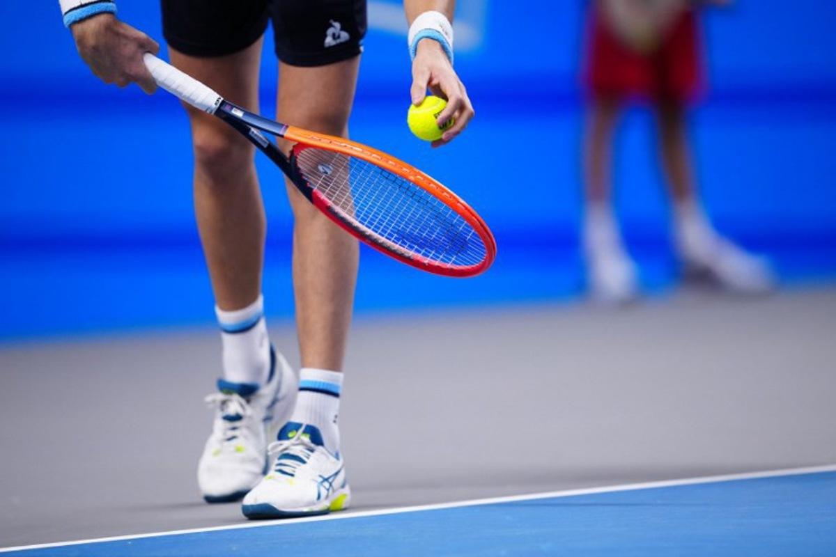 A tennis players holds racquet and ball to play a serve to his opponent during a match of the Erste Bank Open tennis tournament in Vienna on October 26, 2023. Eva MANHART / APA / AFP