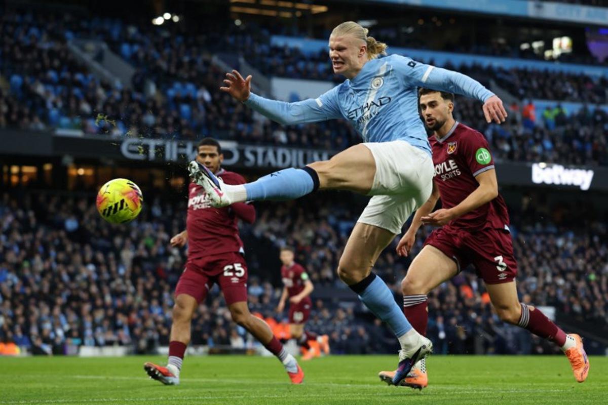Manchester City's Norwegian striker #09 Erling Haaland shoots but misses a chance during the English Premier League football match between Manchester City and West Ham United at the Etihad Stadium in Manchester, north west England, on December 20, 2025. Darren Staples / AFP