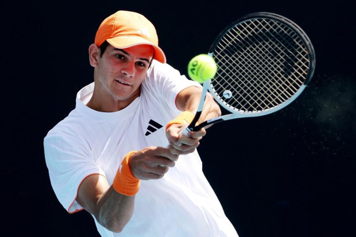 This handout picture released by Tennis Australia on January 22, 2026, shows Spain's Rafael Jodar hits a return to Czech Republic's Jakub Mensik during their men's singles match on day five of the Australian Open tennis tournament in Melbourne. HAMISH BLAIR / TENNIS AUSTRALIA / AFP