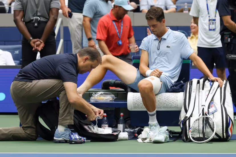 Belgium's Alexander Blockx receives medical attention as he plays Russia's Karen Khachanov in their men's singles quarter-final tennis match on day eleven of the US Open tennis tournament at the USTA Billie Jean King National Tennis Center in New York on September 9, 2026. TIMOTHY A. CLARY / AFP
