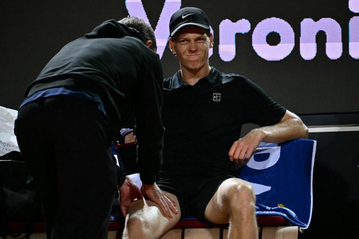 Italy's Jannik Sinner grimaces as he receives a massage during a break in the semi-final match against Russia's Daniil Medvedev at the ATP Rome Open tennis tournament at Foro Italico in Rome on May 15, 2026. Filippo MONTEFORTE / AFP