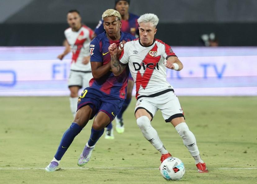 Barcelona's Spanish forward #10 Lamine Yamal fights for the ball with Rayo Vallecano's Spanish defender #03 Pep Chavarria during the Spanish league football match between Rayo Vallecano de Madrid and FC Barcelona at the Vallecas stadium in Madrid on August 31, 2025. Pierre-Philippe MARCOU / AFP