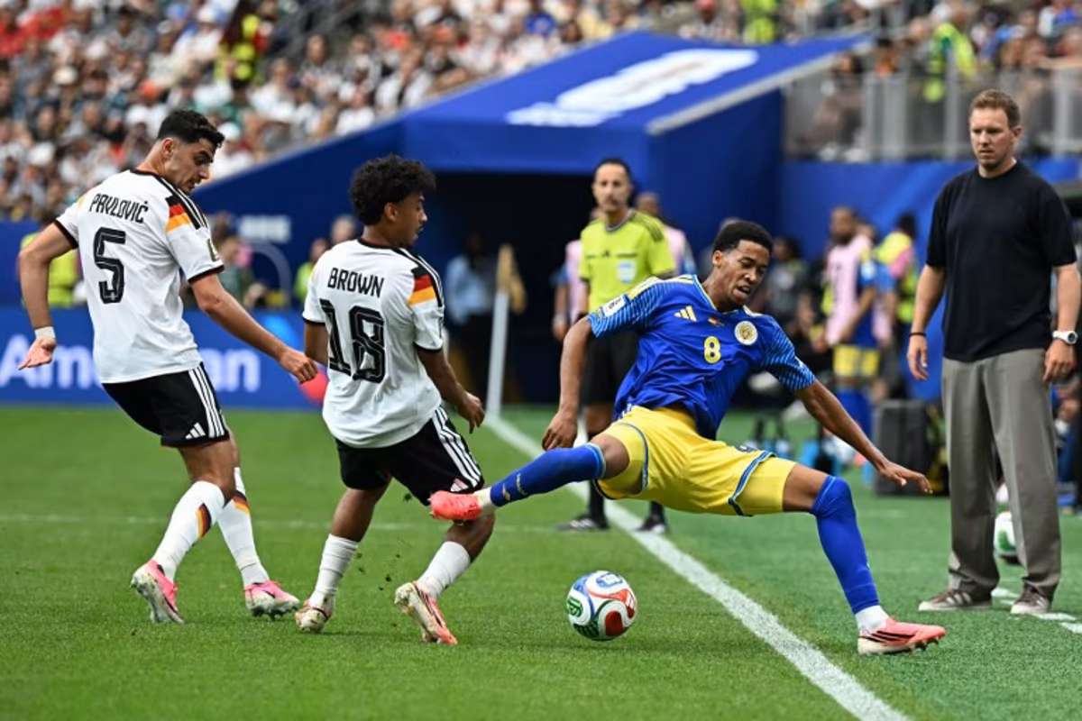 Curacao's midfielder #08 Livano Comenencia (C) is tackled by Germany's defender #18 Nathaniel Brown (2ndL) as Germany's head coach Julian Nagelsmann (R) looks on during the 2026 World Cup Group E football match between Germany and Curacao at the Houston Stadium in Houston on June 14, 2026. Paul ELLIS / AFP