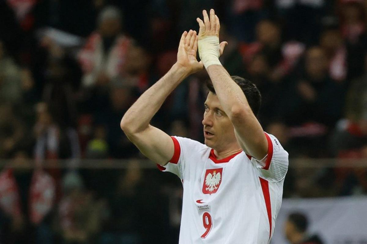 Poland's forward #09 Robert Lewandowski applauds as he goes off during the 2026 FIFA World Cup qualifiers football match between Poland and Lithuania at the National Stadium in Warsaw, Poland on November 21, 2024. Wojtek RADWANSKI / AFP