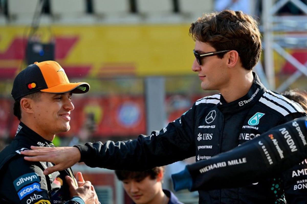 McLaren's British driver Lando Norris and Mercedes' British driver George Russell chat ahead of the Abu Dhabi Formula One Grand Prix at the Yas Marina Circuit in Abu Dhabi on December 7, 2025. Andrej ISAKOVIC / AFP