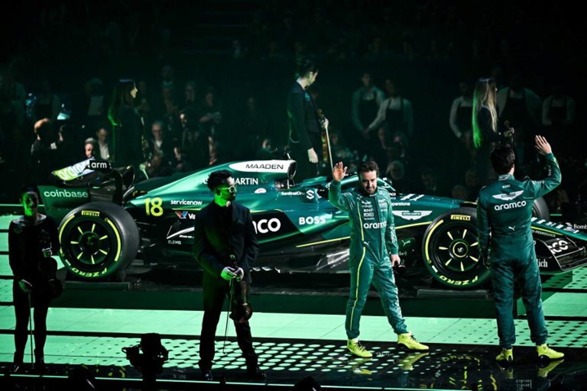 Aston Martin's Spanish driver Fernando Alonso (2nd R) and Aston Martin's Canadian driver Lance Stroll (R) stand by the new Formula 1 car of Aston Martin Formula One Team during the Formula One - 2025 season launch "F1 75 LIVE" event at the O2, in London, on February 18, 2025 Ben STANSALL / AFP