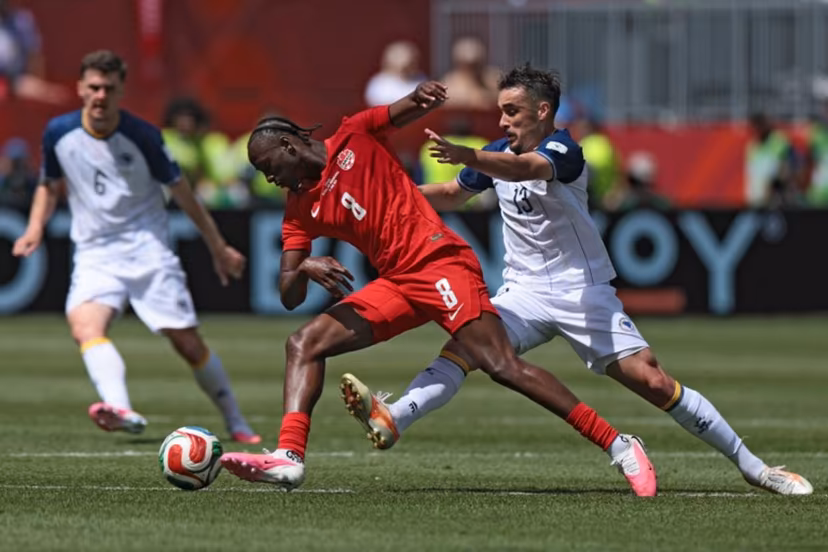 Canada's midfielder #08 Ismael Kone (C) fights for the ball with Bosnia-Herzegovina's midfielder #13 Ivan Basic during the 2026 World Cup Group B football match between Canada and Bosnia and Herzegovina at the Toronto Stadium in Toronto on June 12, 2026. Cole Burston / AFP
