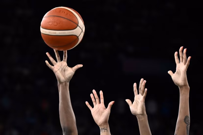 USA's #13 Jackie Young (L) and France's #11 Valeriane Ayayi go for a rebound in the women's Gold Medal basketball match between France and the USA during the Paris 2024 Olympic Games at the Bercy Arena in Paris on August 11, 2024. Aris MESSINIS / AFP