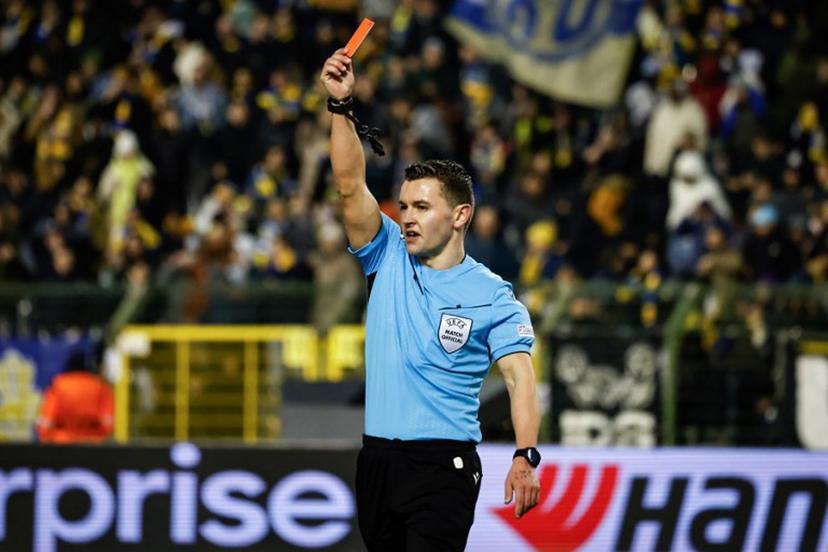 Referee Nicholas Walsh holds a red card during the UEFA Europa League, league phase football match between Royale Union Saint-Gilloise and SC Braga at the King Baudouin Stadium in Brussels, on January 23, 2025. Simon Wohlfahrt / AFP
