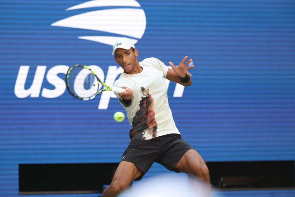 Canada's Felix Auger-Aliassime plays a forehand return to Australia's Alex De Minaur during their men's singles quarterfinal tennis match on day eleven of the US Open tennis tournament at the USTA Billie Jean King National Tennis Center in New York City, on September 3, 2025. TIMOTHY A. CLARY / AFP