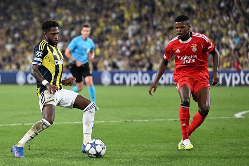 Fenerbahce's Brazilian midfielder #7 Fred (L) kicks the ball next to Benfica's Portuguese midfielder #61 Florentino (R) during the UEFA Champions League play off first leg football match between Fenerbahce (TUR) and Benfica (POR) at the Fenerbahce Sukru Saracoglu Sport Complex in Istanbul on August 20, 2025. Ozan KOSE / AFP