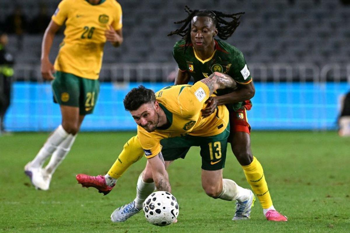 Australia's Aiden O'Neill (L) reacts after being tackled by Cameroon's Ryan Fosso (R) during the international friendly football match between Australia and Cameroon at Stadium Australia in Sydney on March 27, 2026. SAEED KHAN / AFP