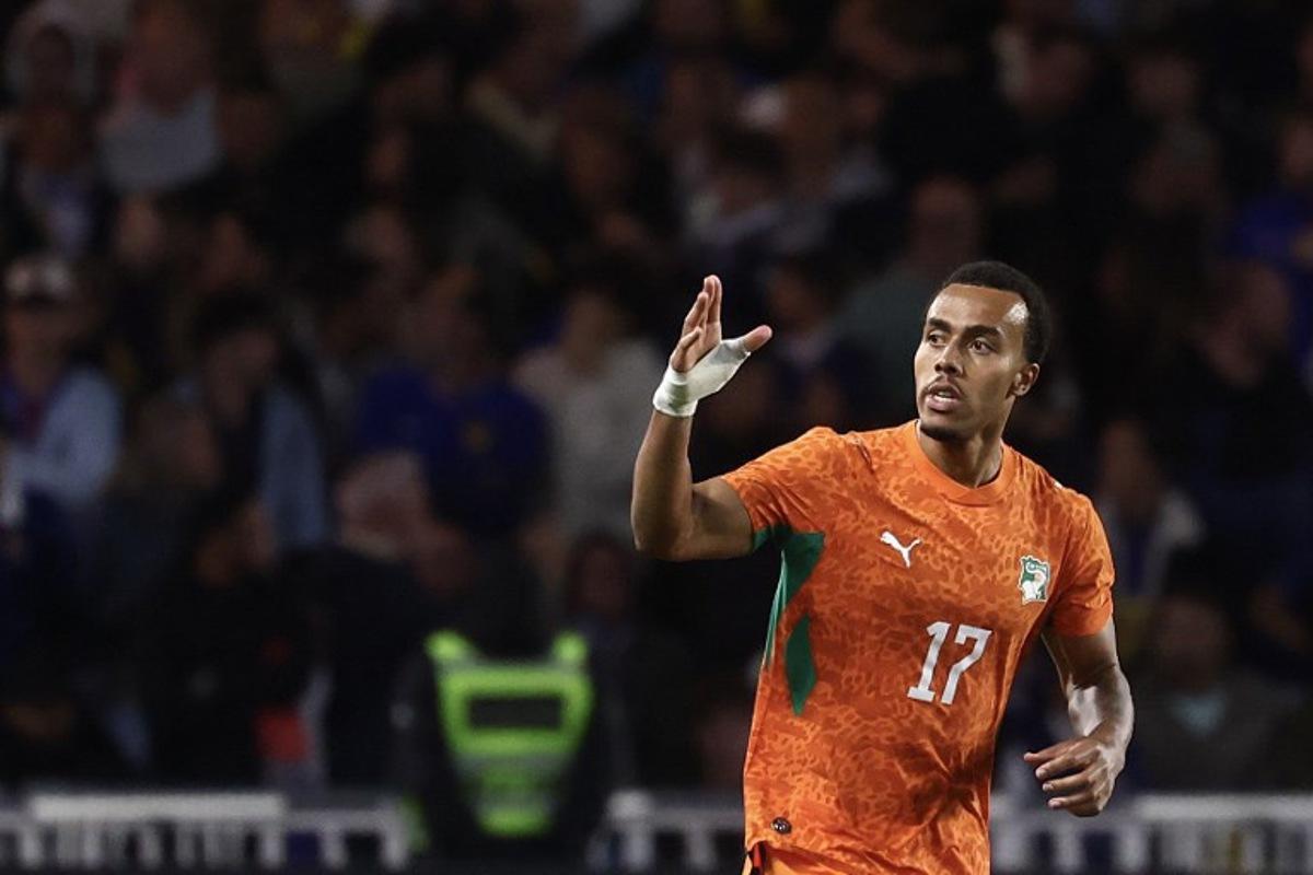 Ivory Coast's defender #17 Guela Doue celebrates scoring the equalizing goal during the international friendly football match between France and Ivory Coast ahead of the 2026 FIFA World Cup football tournament at the Stade de la Beaujoire in Nantes, western France, on June 4, 2026. FRANCK FIFE / AFP