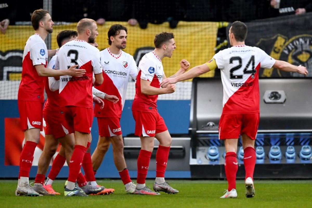 Utrecht's Danish midfielder #22 Oscar Fraulo (2nd R) celebrates after scoring a goal during the Dutch Eredivisie first division football match between FC Utrecht and NAC Breda at the Galgenwaard stadium in Utrecht in Utrecht on March 1, 2025. Gerrit van Keulen / ANP / AFP