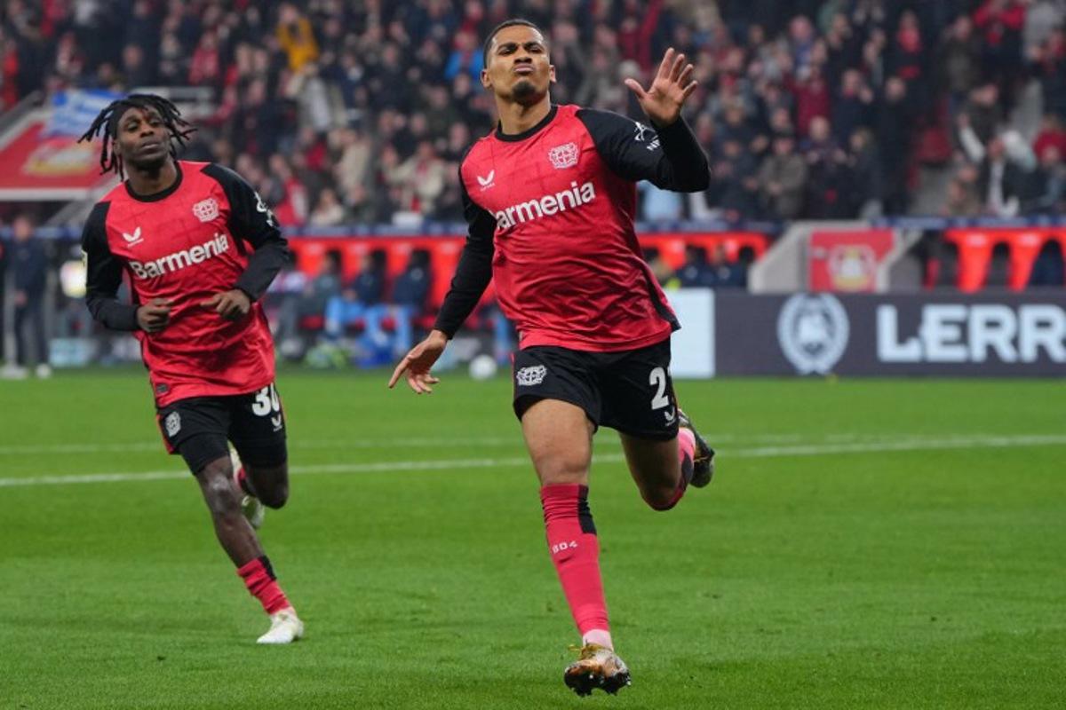 Bayer Leverkusen's French forward #21 Amine Adli (R) celebrates scoring the 3-1 goal with his teammate Dutch defender #30 Jeremie Frimpong during the German first division Bundesliga football match between Bayer 04 Leverkusen and VfL Bochum in Leverkusen, western Germany on March 28, 2025. Pau BARRENA / AFP