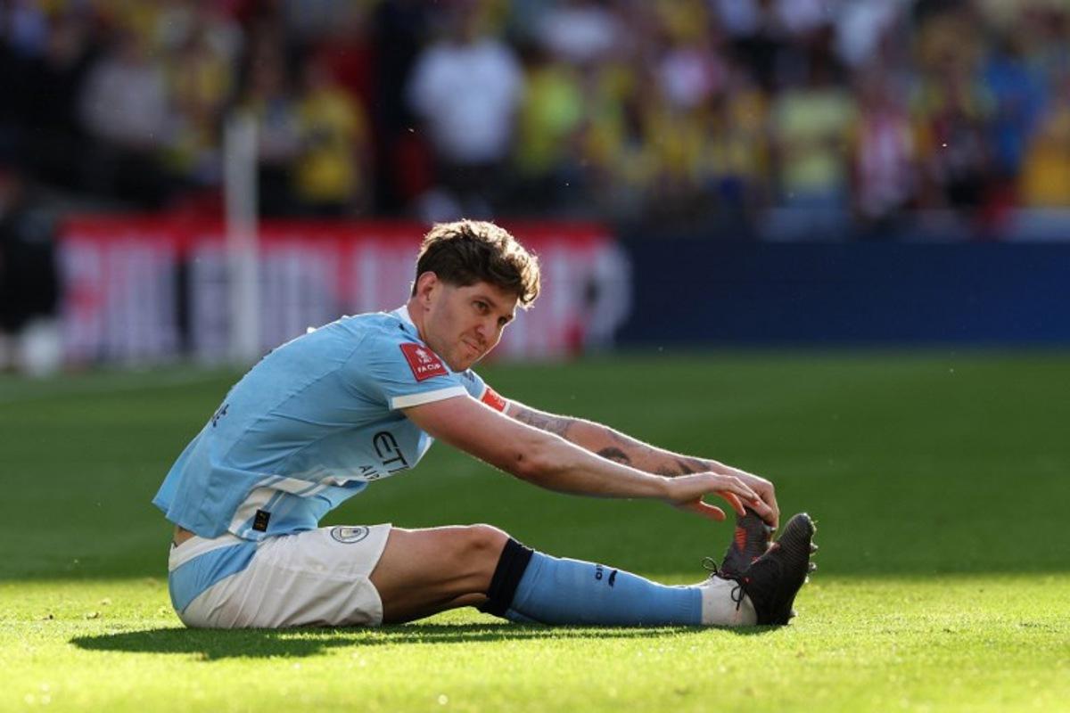 Manchester City's English defender #05 John Stones reacts after suffering a knock during the English FA Cup semi final football match between Manchester City and Southampton at Wembley stadium in London, on April 25, 2026. Adrian Dennis / AFP